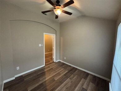 Unfurnished room with vaulted ceiling, hardwood / wood-style floors, and ceiling fan