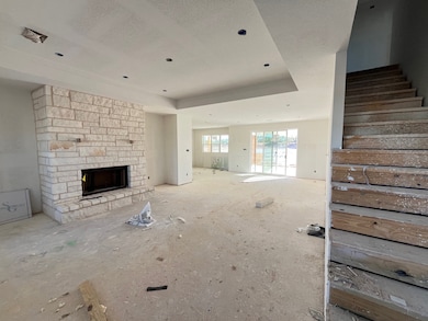 Unfurnished living room with a stone fireplace