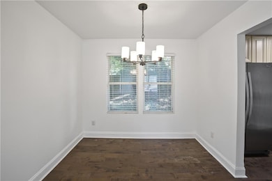 Unfurnished dining area featuring dark wood-style floors