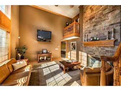 2 story great room with stone fireplace and wall o