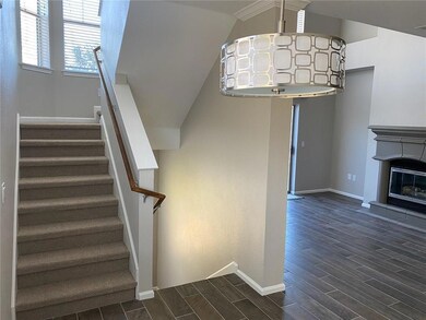 Stairs with baseboards, wood finished floors, lof
