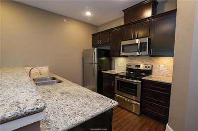 Kitchen featuring a sink, stainless steel applianc