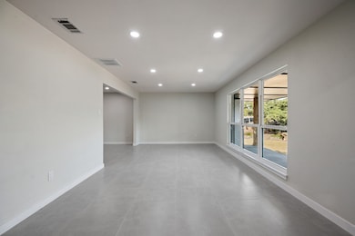 Empty room featuring baseboards and recessed lighting