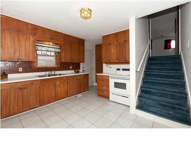 Kitchen view with stairs leading up to master bedr