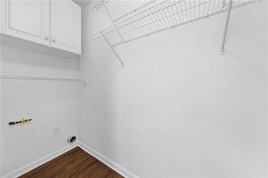 Large laundry room with cabinetry located in kitchen area