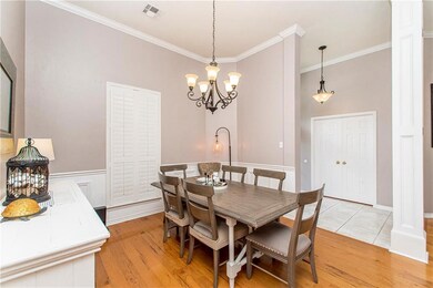 Dining room with shutters, wainscoting and nice li