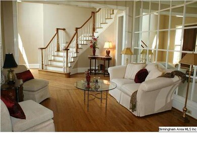 Tasteful living room with view of curved staircase