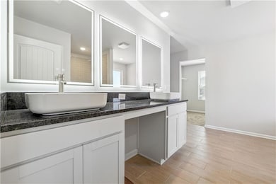 Full bath with a sink, baseboards, double vanity, 
