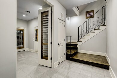 French doors & wrought iron staircase hardwoods
