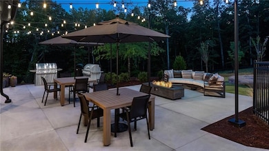 View of patio / terrace with outdoor dining space, an outdoor living space with a fire pit, and grilling area
