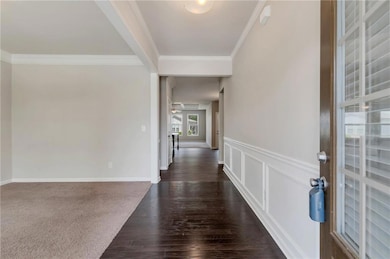 Entryway featuring crown molding, a ceiling fan, d