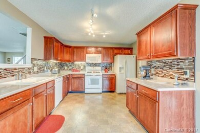 Kitchen features cabinets galore!, backsplash, and