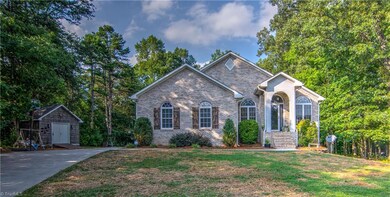 Front of home, paved drive, detached storage bldg.