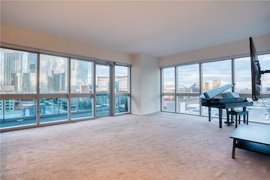 Living room with carpet flooring, healthy amount of natural light, and a city view