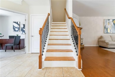 Stairway featuring baseboards and tile patterned floors