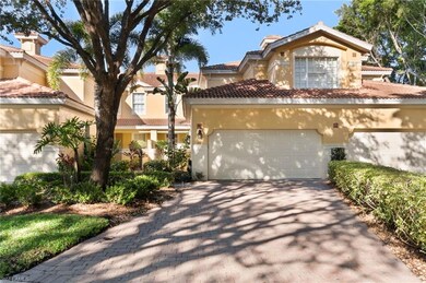 View of front of property with asphalt driveway, stucco siding, and a tiled roof