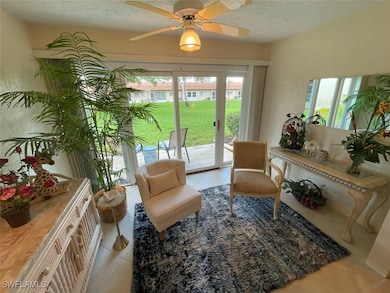 Living area featuring tile patterned floors, a cei
