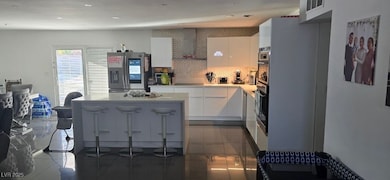Kitchen featuring white cabinets, visible vents, a