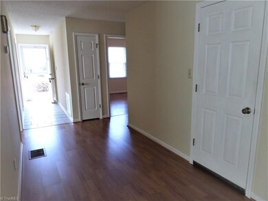 Bright foyer with a coat closet and light fixture! Recently painted interior.