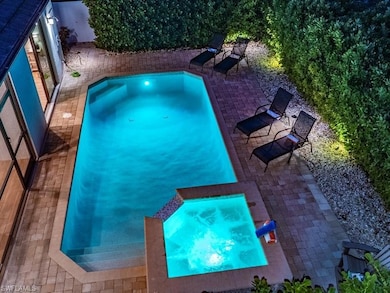 View of pool featuring a patio and an in ground hot tub