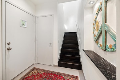 A formal entry with a closet leads to the stairs t