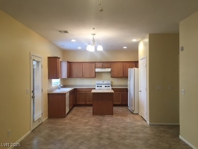 Kitchen featuring stove, under cabinet range hood,
