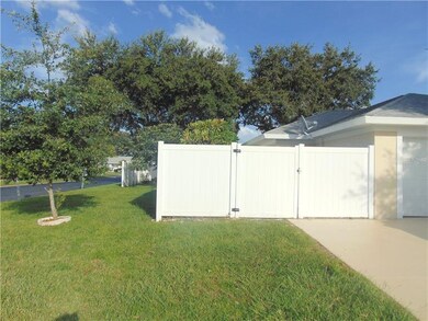 Left side of home with privacy fence hiding a conc