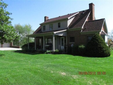 Rear view of the home and covered porch