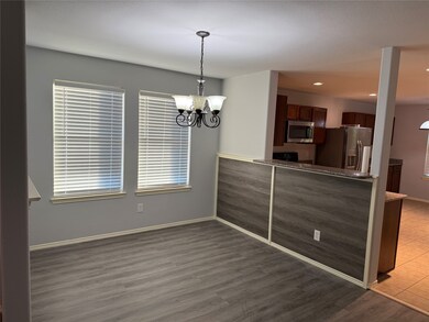 Kitchen featuring a peninsula, pendant lighting, stainless steel appliances, a chandelier, and recessed lighting