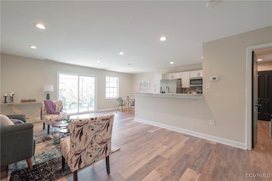Living room with new LVP flooring, baseboards, and