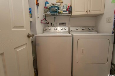 Clothes washing area featuring cabinets and indepe