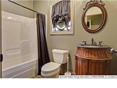 This full bath is on the kitchen side of the house. Part of the triple split floor plan. Perfect floorplan to use this bedroom/bath as office, mother-in-law suite, for older childen, or a workout room
