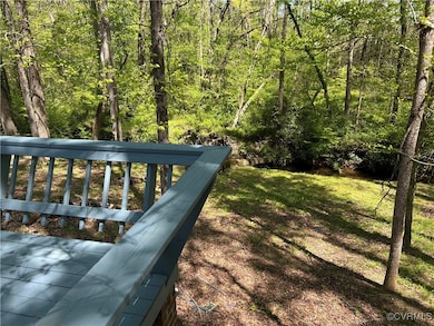 View of yard with a forest and creek view