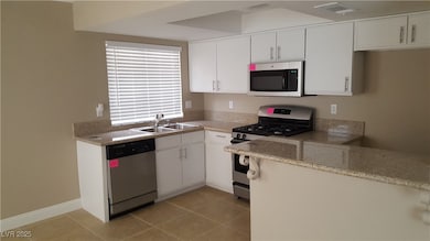 Kitchen featuring stainless steel appliances, a si