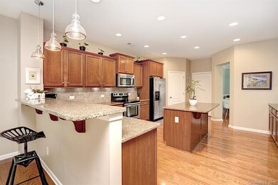 The gourmet kitchen has a pull up bar & lots of granite counter top space
