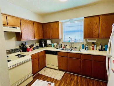 Kitchen featuring dark wood-type flooring, under c