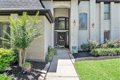 Brick elevation and lush landscaping create lovely