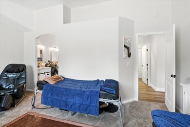 Bedroom featuring arched walkways and carpet