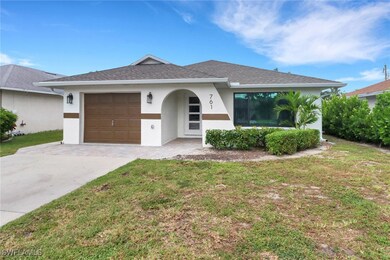 Single story home featuring a garage and a front y