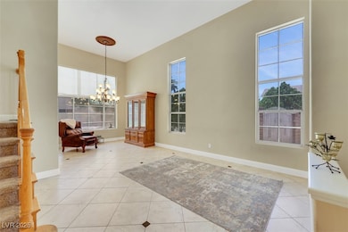Entryway with light tile patterned floors, stairwa