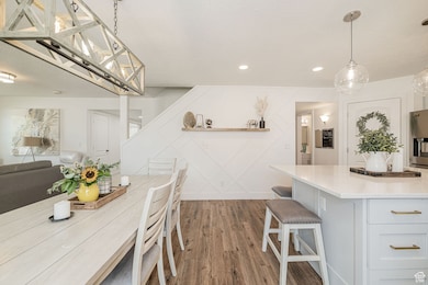 Dining area featuring dark wood finished floors, a textured ceiling, and recessed lighting