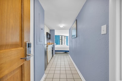 Corridor featuring light tile patterned flooring a