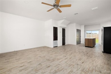 Unfurnished living room featuring light wood finished floors and ceiling fan
