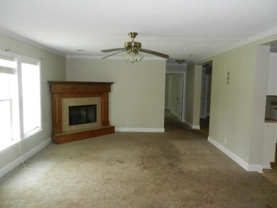 Unfurnished living room with ornamental molding, c