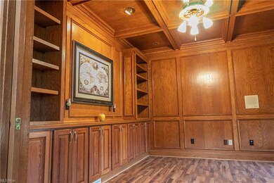 First floor office with built in bookshelves, cupboards and beautiful crown molding ceiling