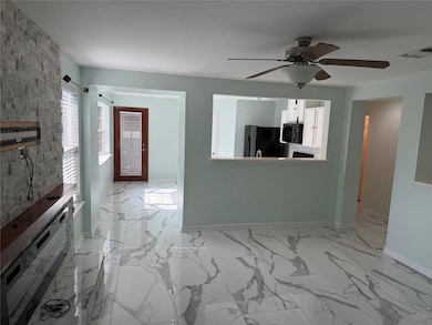 Unfurnished living room with ceiling fan, baseboa