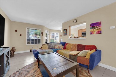 Living room with light tile patterned flooring, a