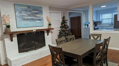 Dining area featuring wood finished floors and ornamental molding