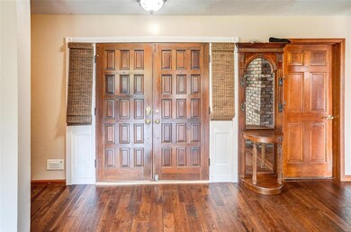 Front doors with side lights and door to garage