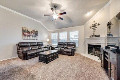 Living room featuring crown molding, ceiling fan, and light colored carpet